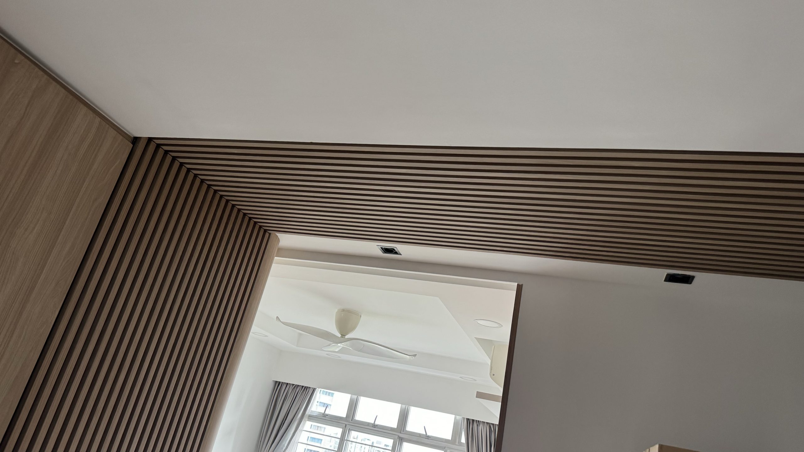 Electrical work by Everyday Renovation in Singapore, featuring a stylish wood-paneled ceiling with recessed lighting and a modern fan installation