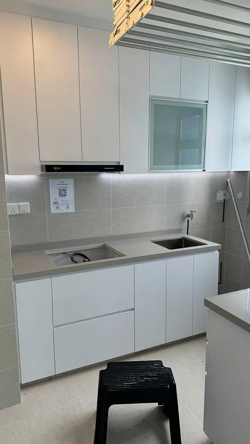 Dark gray marble-tiled walls and floor in a room with two gridded windows, part of a Home Renovation in Singapore.