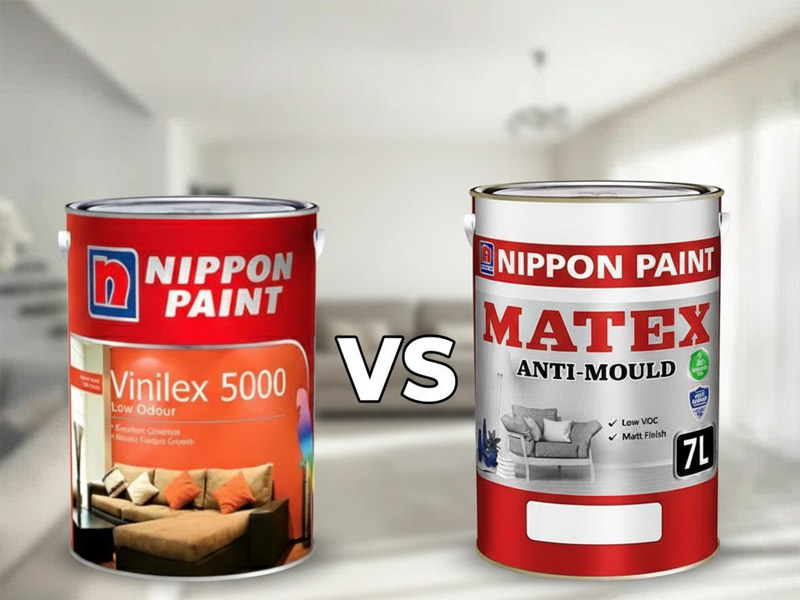 Construction worker suspended high on a building wall painting the exterior, illustrating the heavy-duty application relevant to comparing Nippon Matex vs Nippon Vinilex 5000 exterior paints.