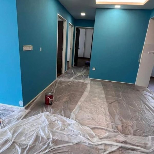 An Everyday Renovation painter in Singapore applying Nippon Matex paint on a wall, providing a budget-friendly solution and clear details on the total Nippon Matex Painting Cost